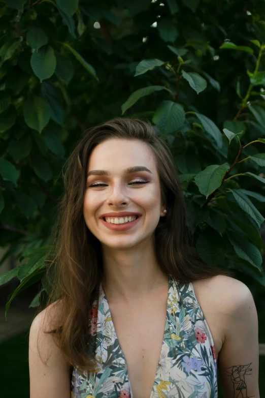 a beautiful woman with long hair in a floral dress