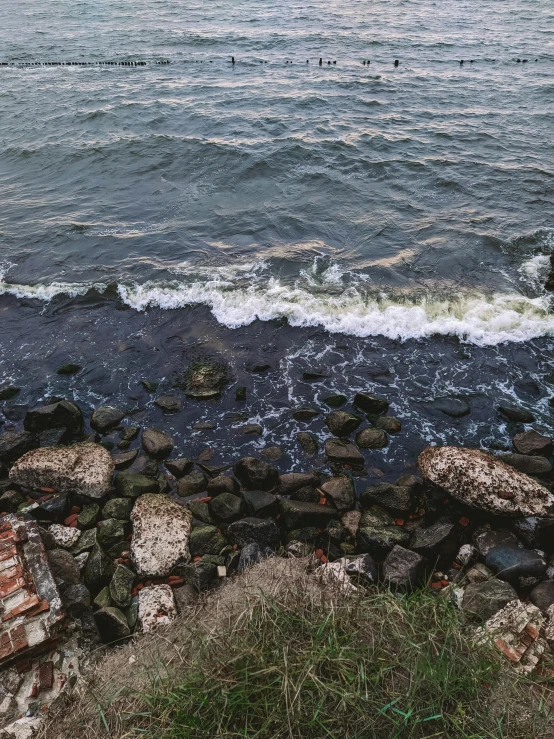 the water is choppy and low to meet the rocks