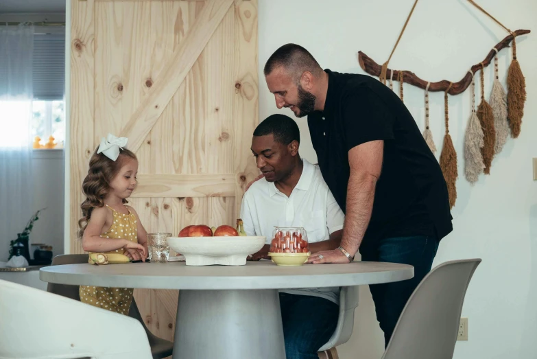 a father and his daughter blowing out candles on a birthday cake