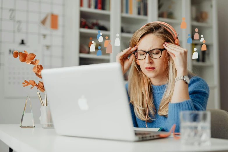 a woman sitting at a table using a laptop