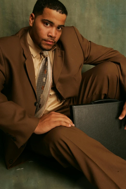 a man in a suit holding a laptop