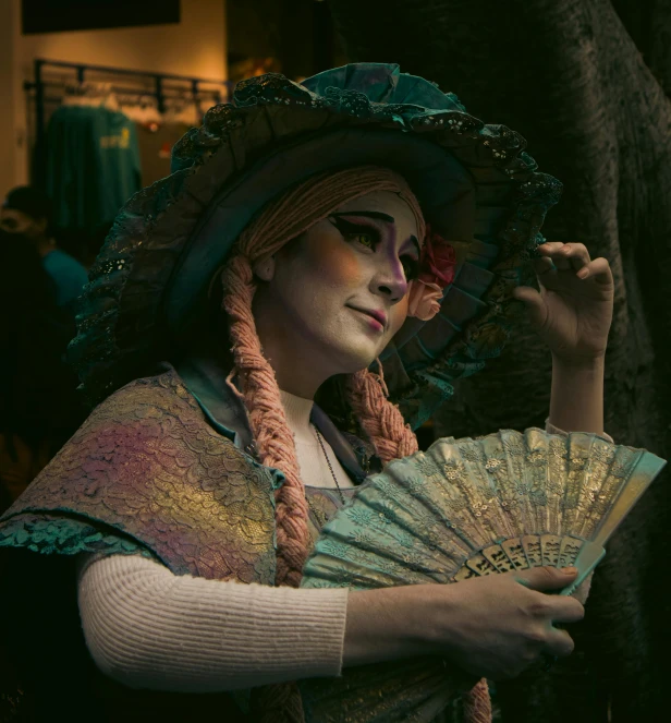a woman dressed in costumes holding a parasol
