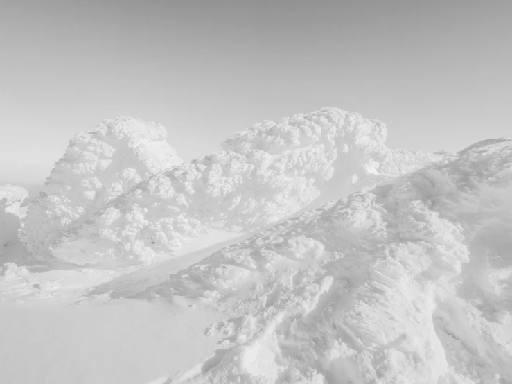 two people on skis are skiing near very huge snow