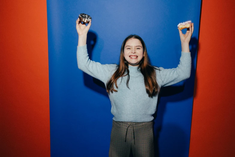 a  holding a doughnut while wearing slacks