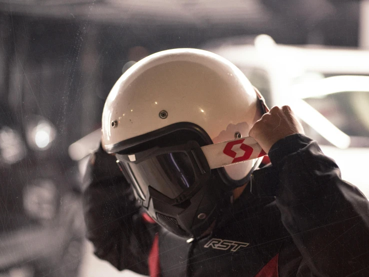 a boy wearing a white helmet in front of a street