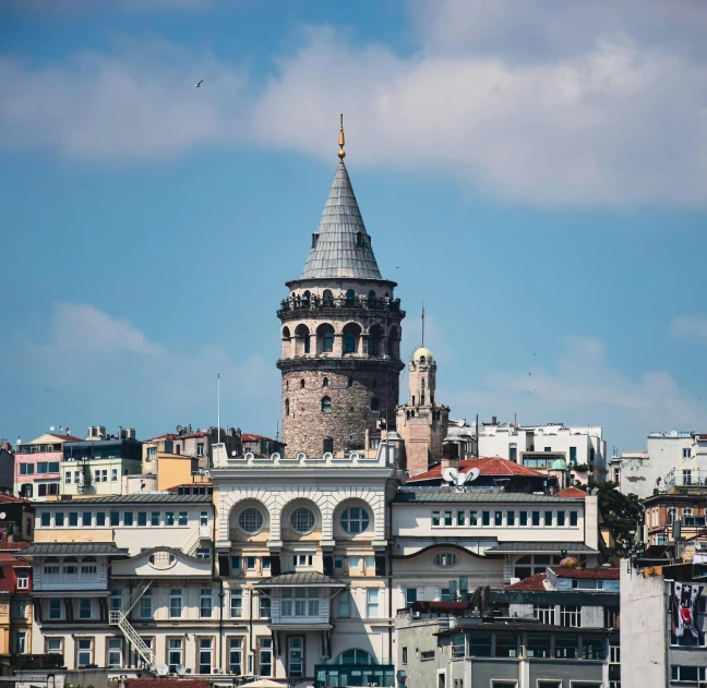 a clock tower is on the top of a building in a city