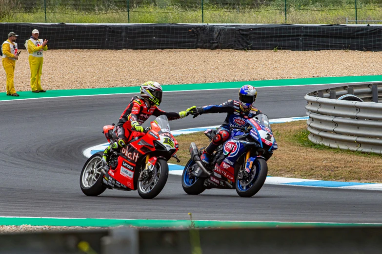 two people on motorcycles one holding on to the other