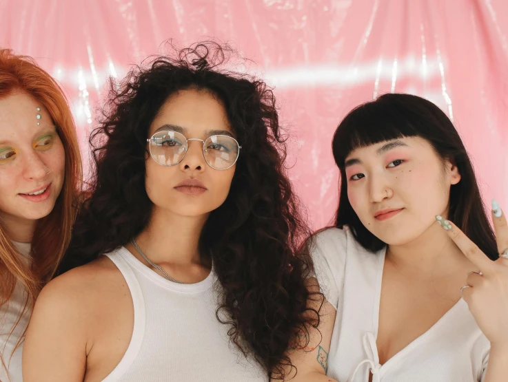 three women wearing glasses and posing for the camera