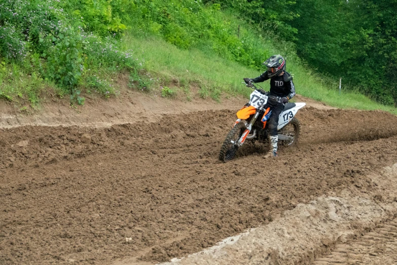 a man riding a dirt bike on top of a race track