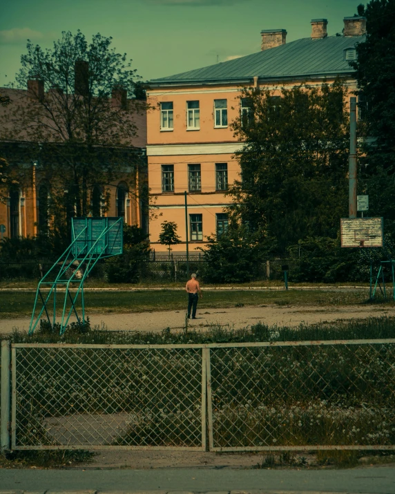 a small child playing in a yard with some buildings