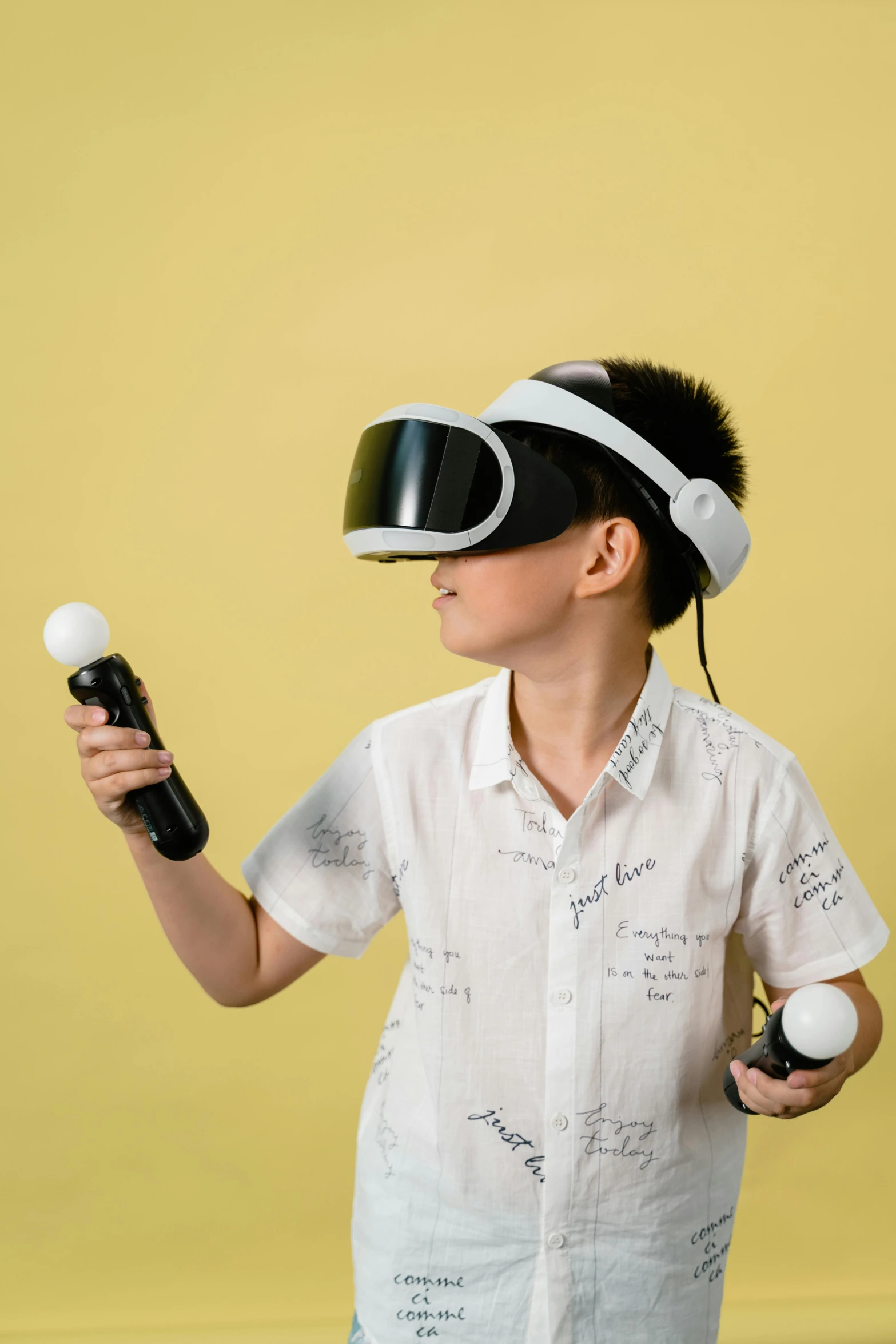 boy holding an object while wearing virtual reality glasses