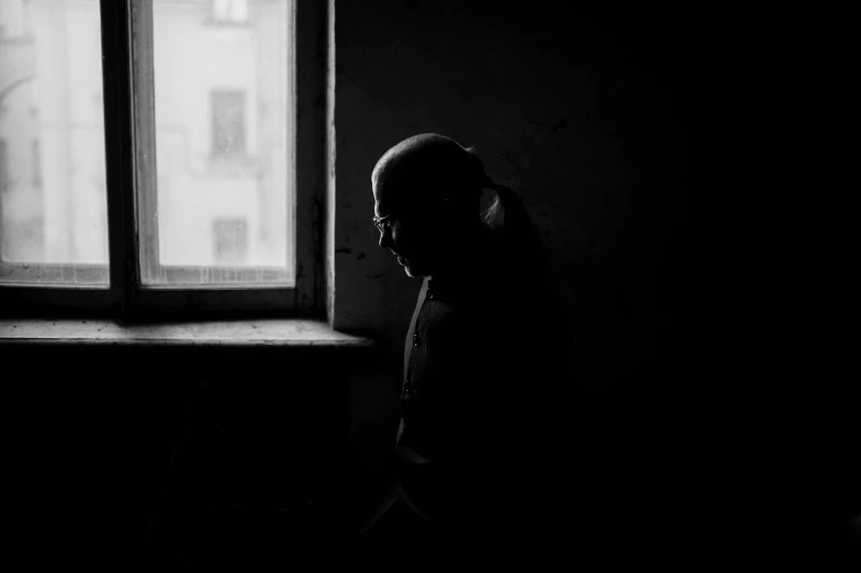 a woman in headphones looking out the window at building