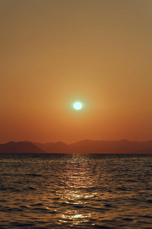 a boat is on the water at sunset