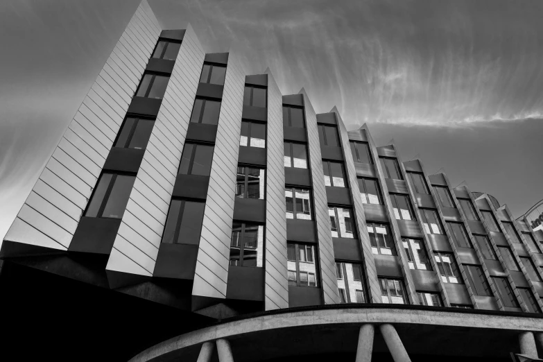 building designed over bridge with cloudy sky in background