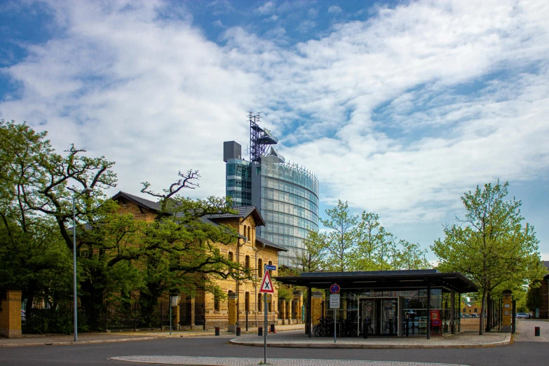 an empty bus station next to the city buildings