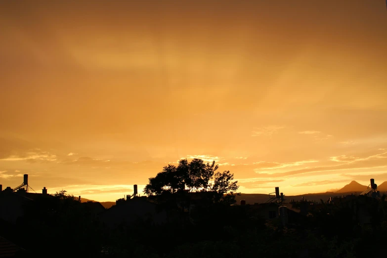 a sunset that is over a city and trees