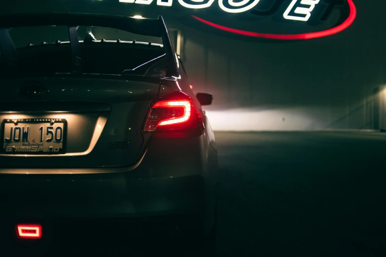 the back end of a car parked in a dimly lit room