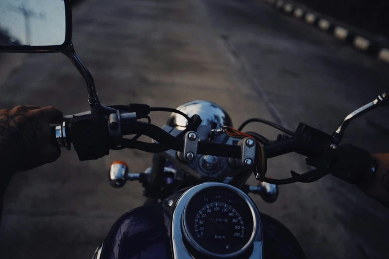 a motorcycle with a speed gauge in front of the mirror