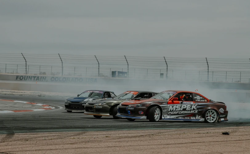 two racing cars doing stunts on a track