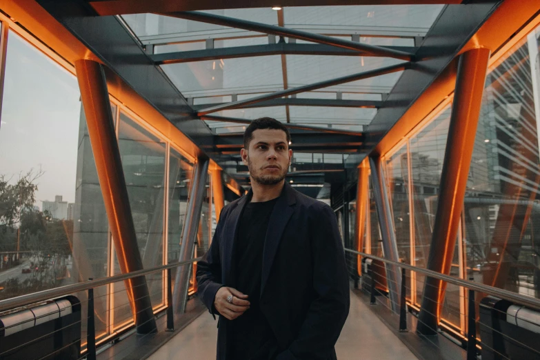 a man standing in a tunnel by an outside building