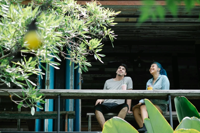 two people sit on a bench while looking into the distance