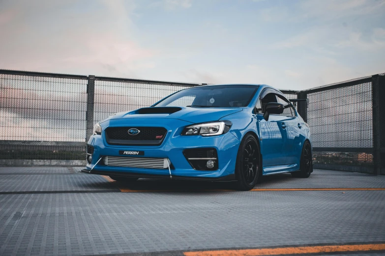 a blue car parked in front of a building