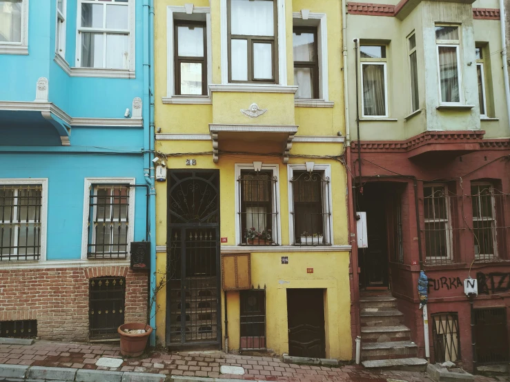 the multicolored houses have a few doors and windows