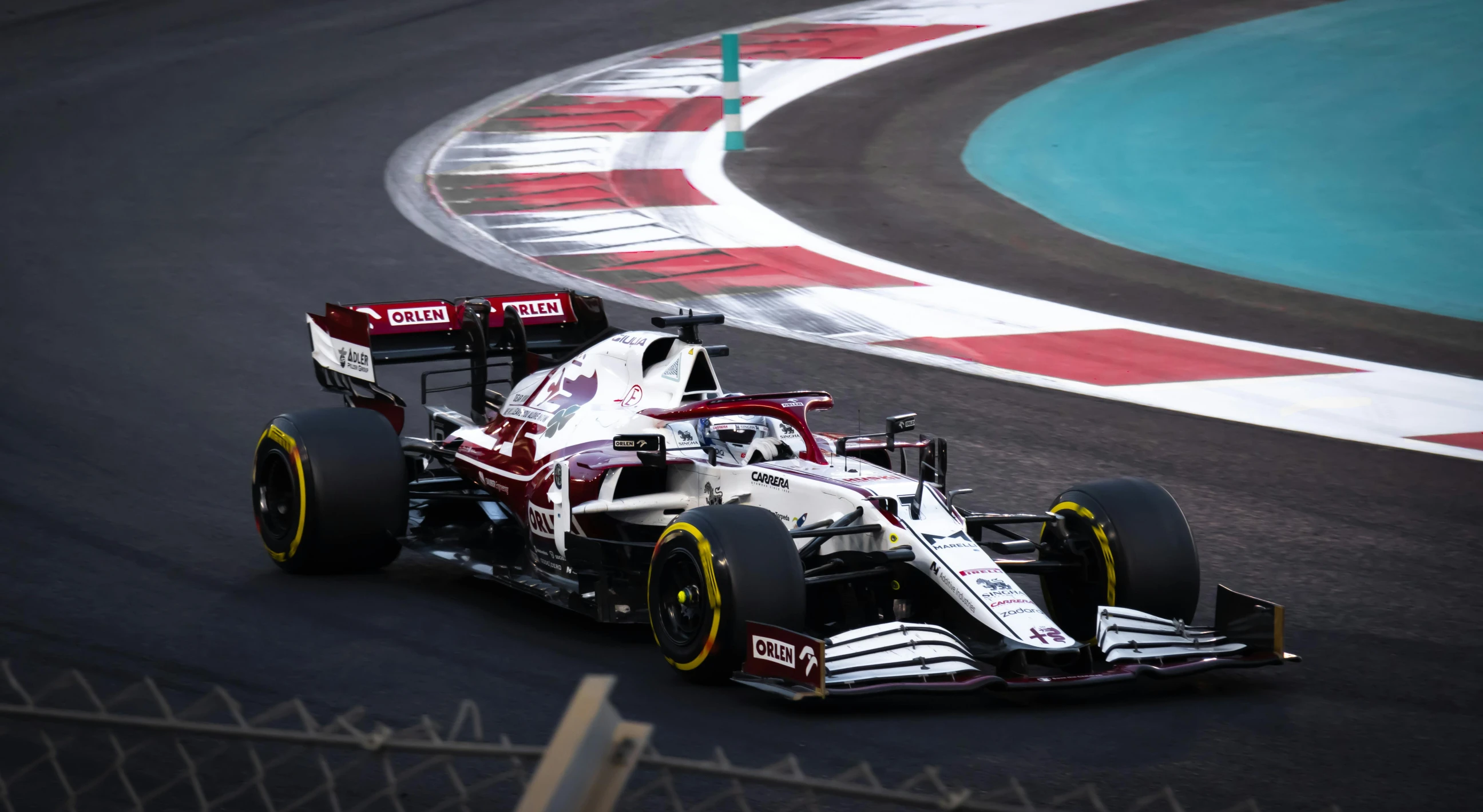 a close up of a race car driving on a track