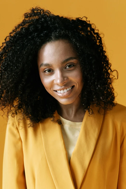 a young woman smiles brightly in the sunlight