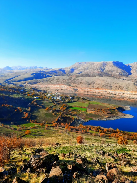 a beautiful mountain landscape with a lake below