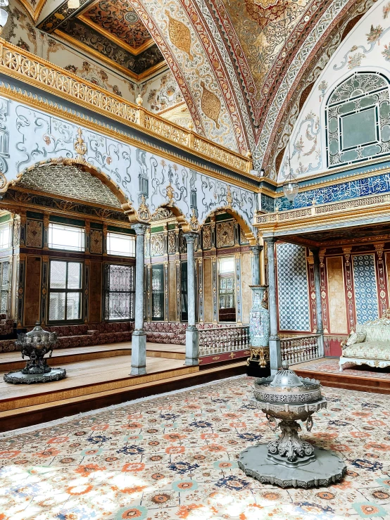 inside a palace, intricately decorated carpet is in the center