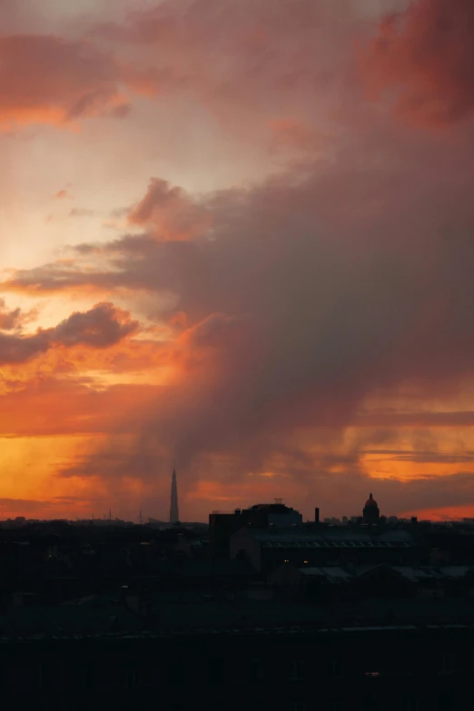 a sunset and cityscape as seen from the ground