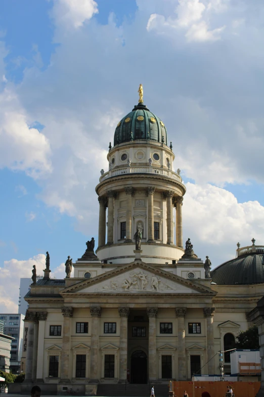 a building with columns, a dome and many decorations around it