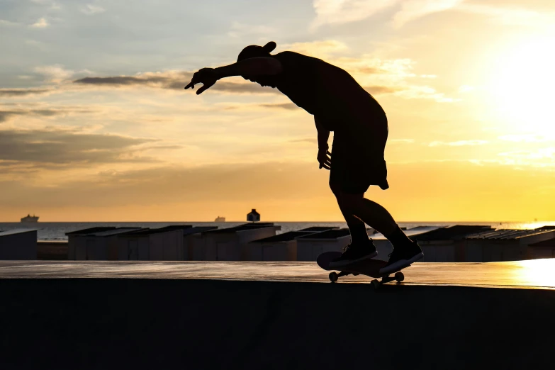 a skateboarder is riding on the edge of a wall