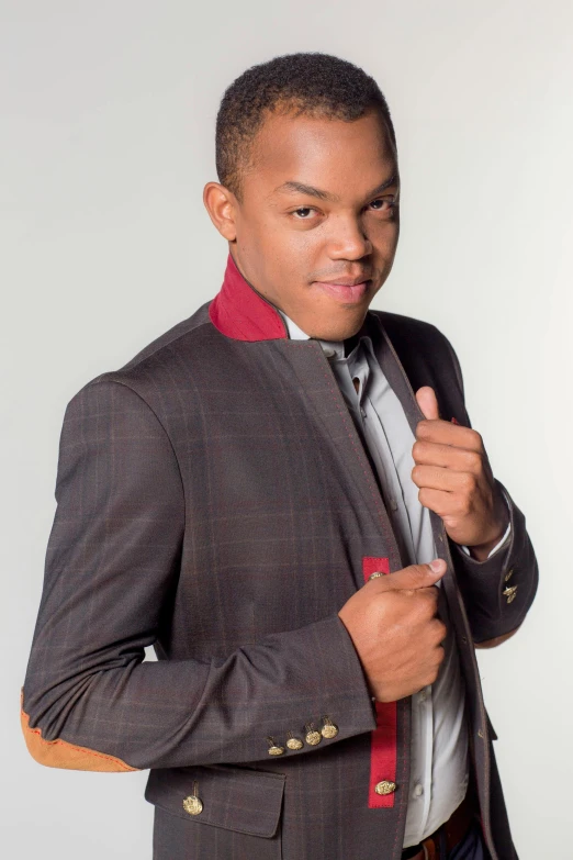 a man in a suit straightens his tie