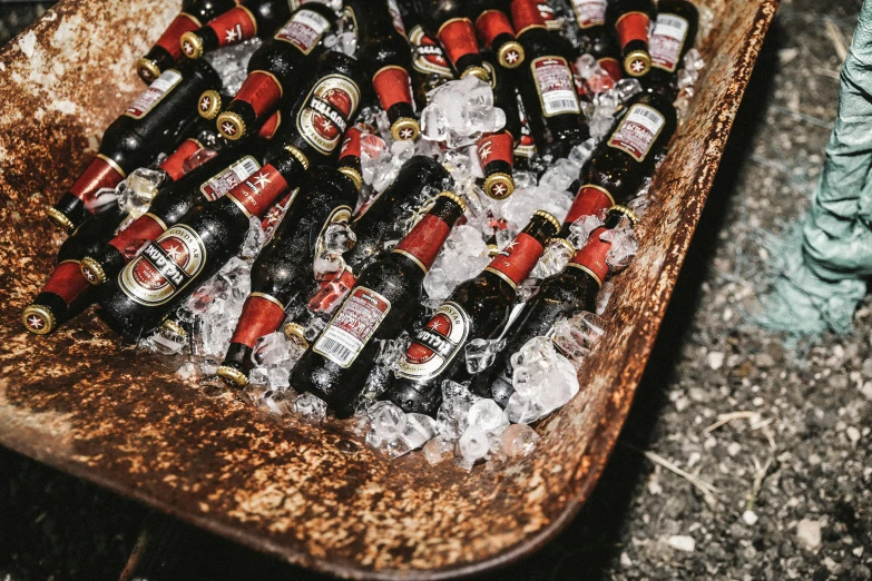 an assortment of bottled alcohol sits on top of some ice