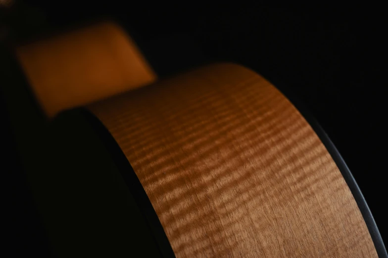 a guitar neck is shown with the back light reflecting off of it