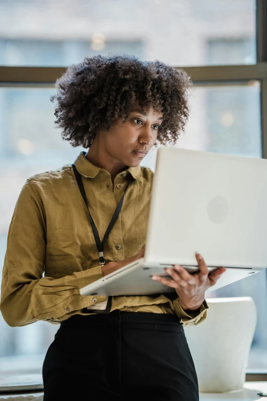 a woman using her lap top computer at an office