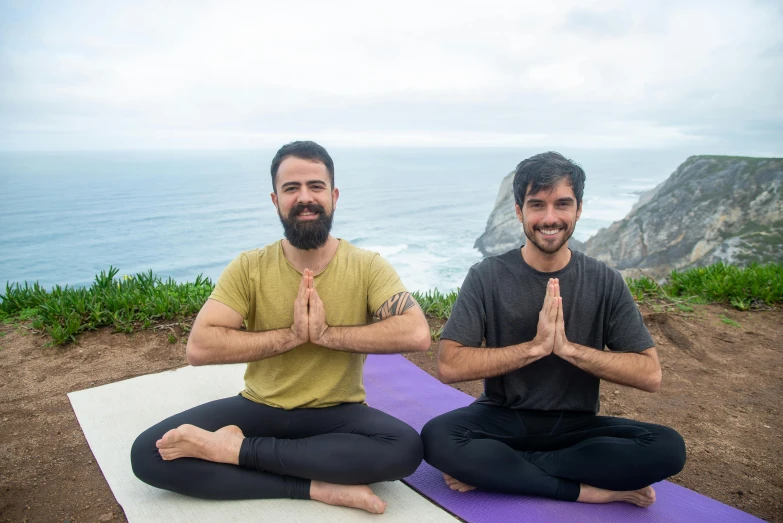 two men in a yoga pose for a pograph
