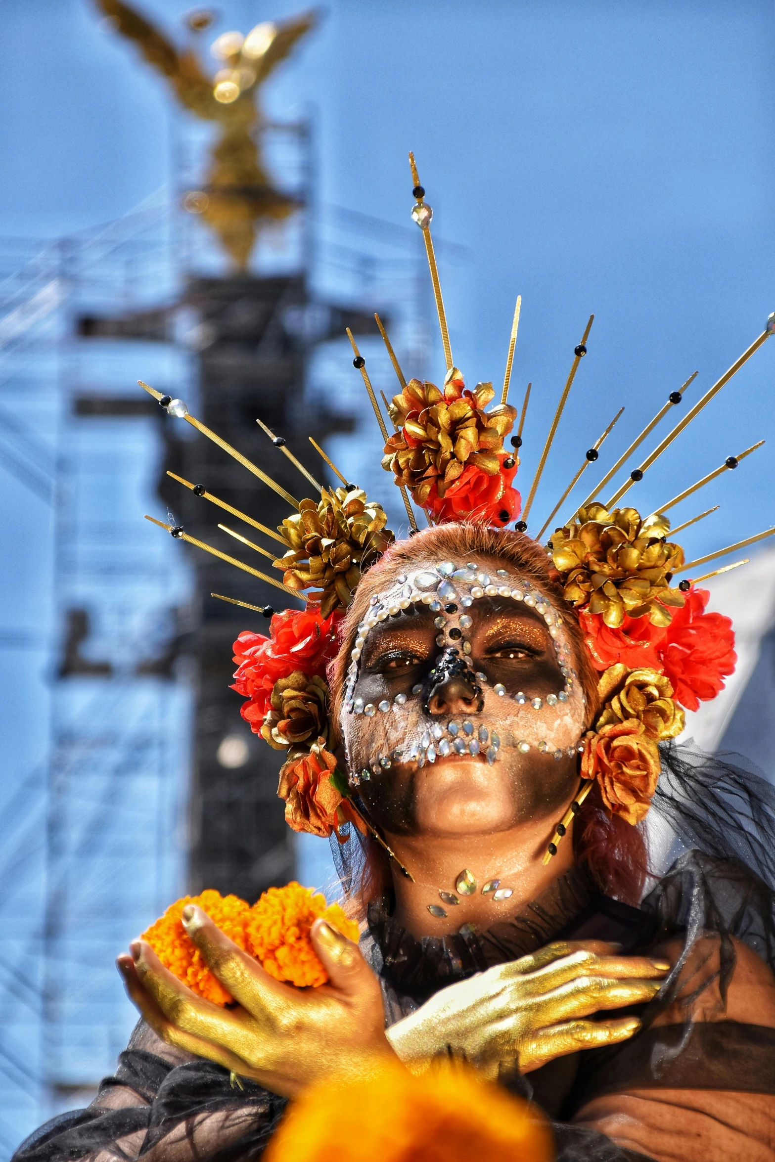 there is a man wearing gold and silver face makeup