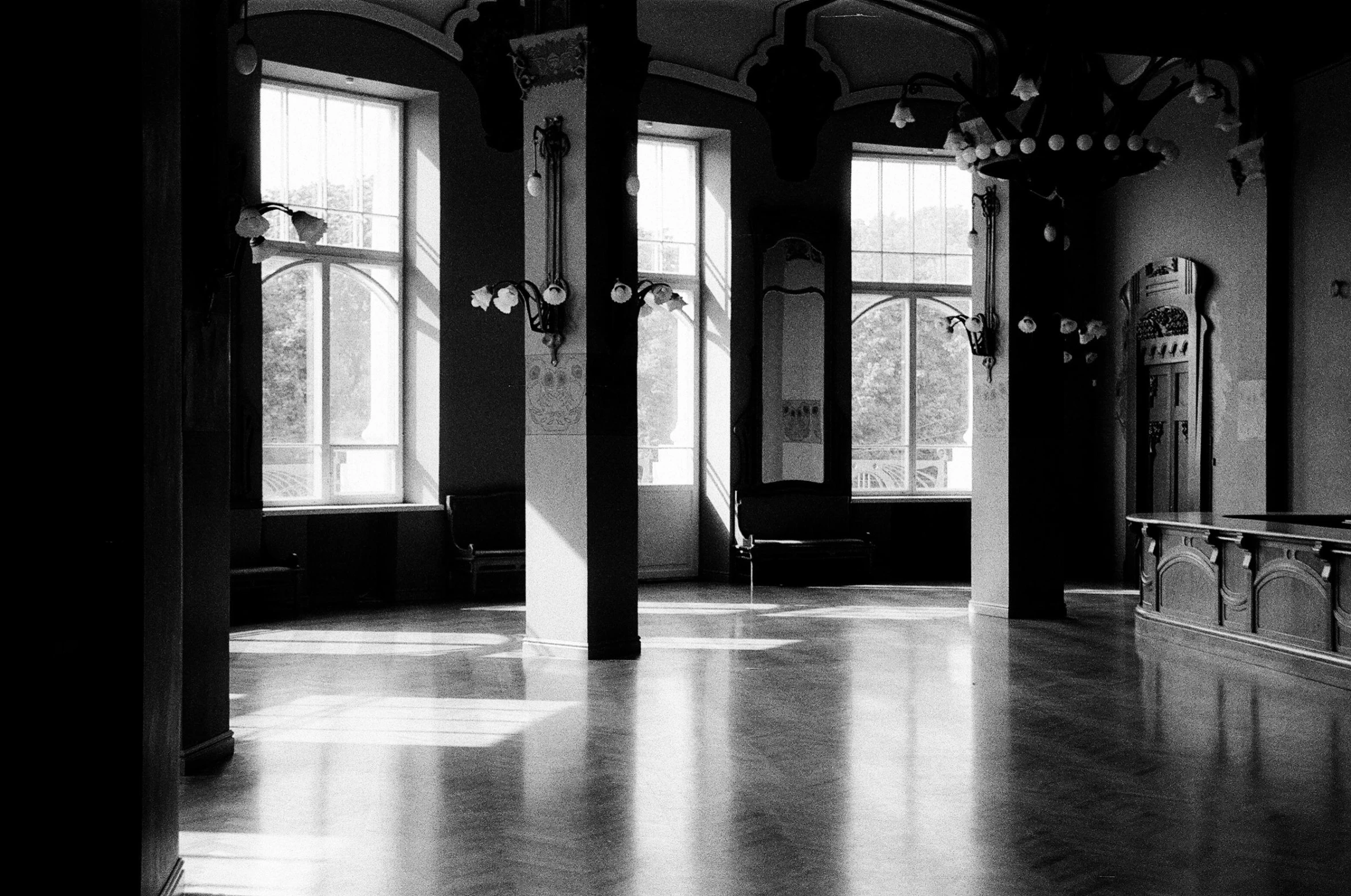 the interior of an old church with white walls and stained windows