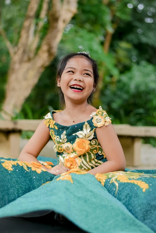 a little girl standing on the ground smiling for a po