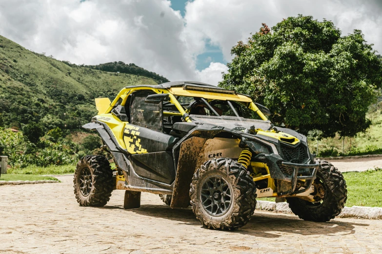 the side view of a black and yellow can - am spyder