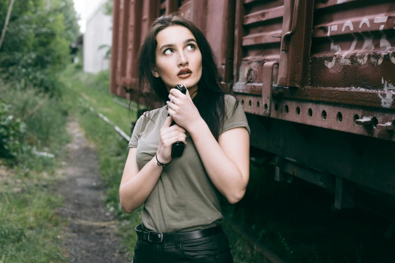 a woman is leaning on the rail of a train