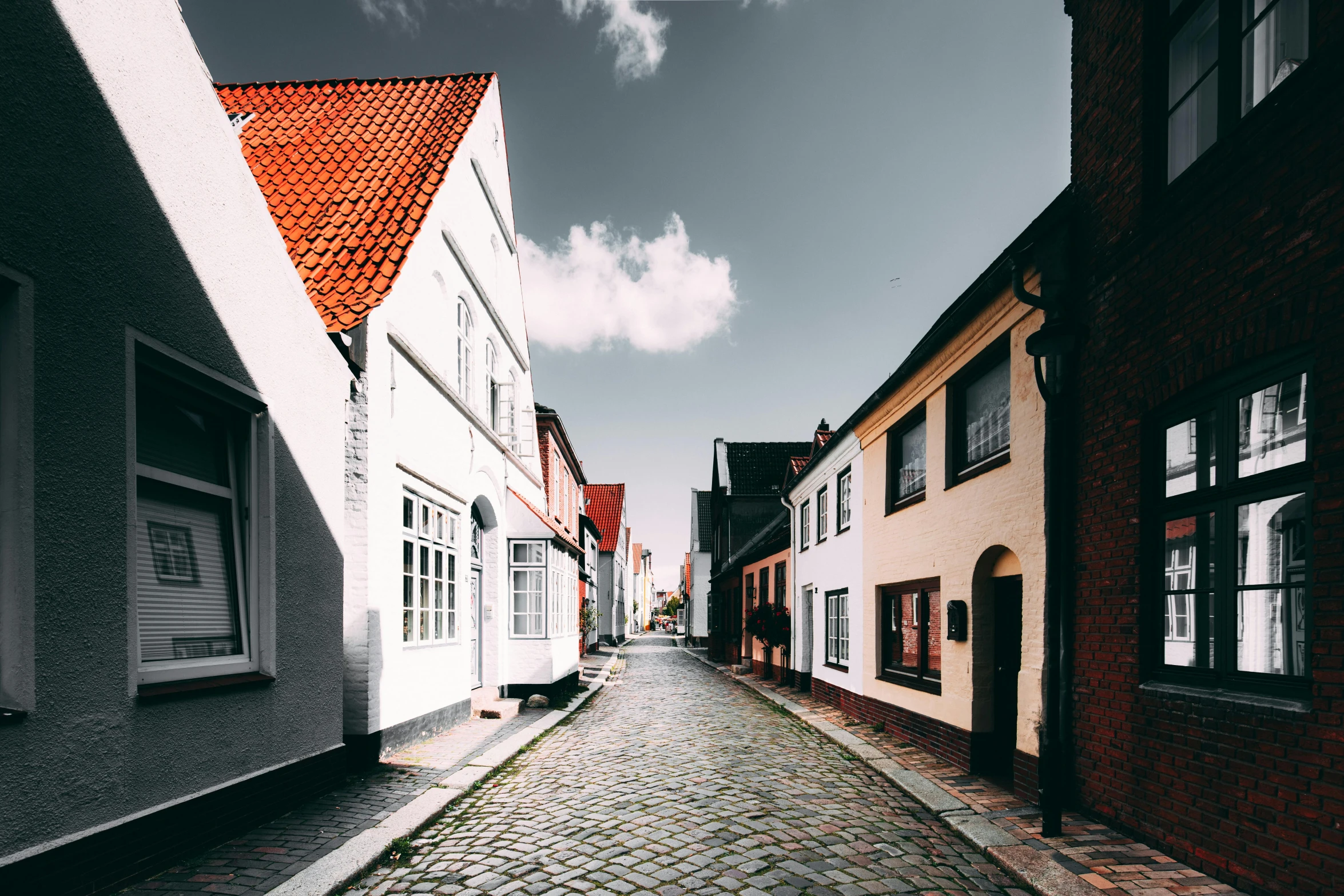 a cobbled street in the heart of a brick city