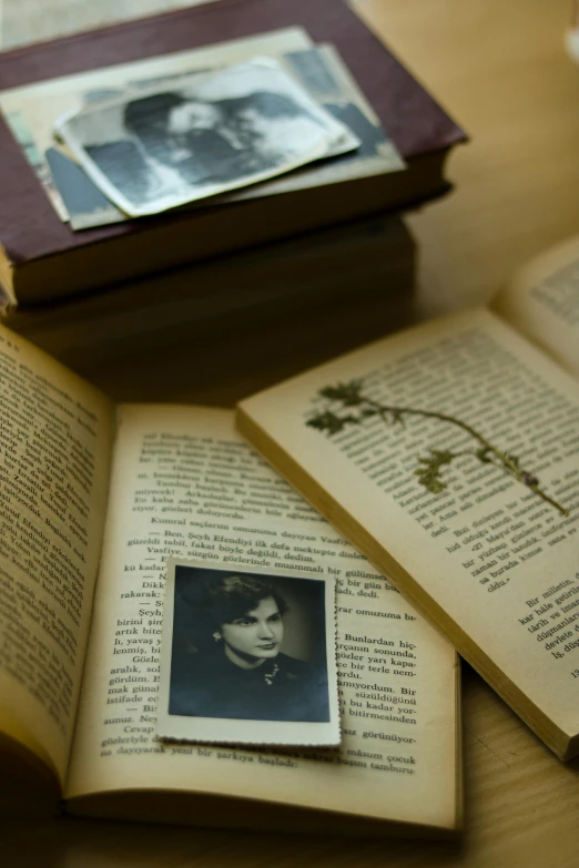 a po, book and album on a table