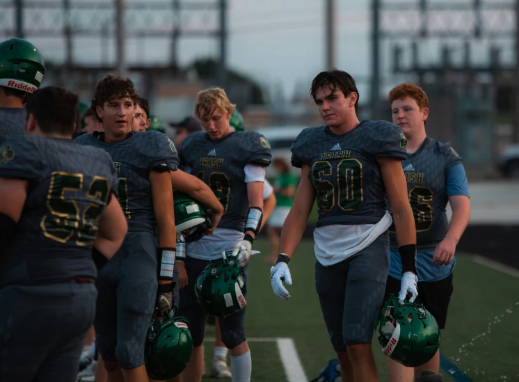 several young football players huddle together on the field