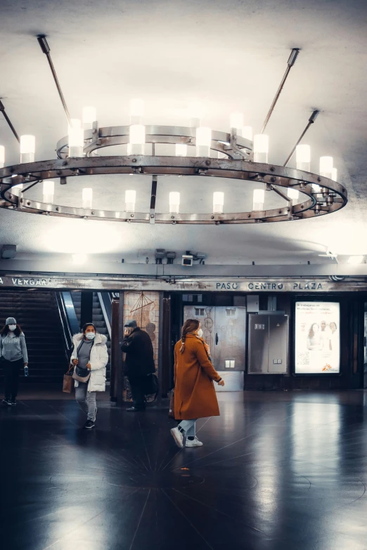 a woman in a yellow jacket in an airport terminal