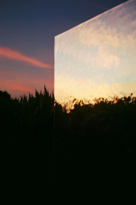 a mirror reflection shows the sky and clouds