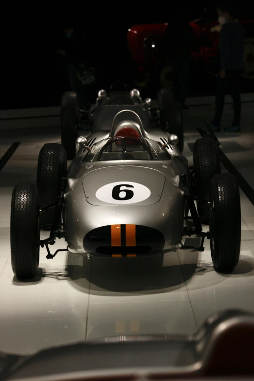 there is a race car on display in the dark